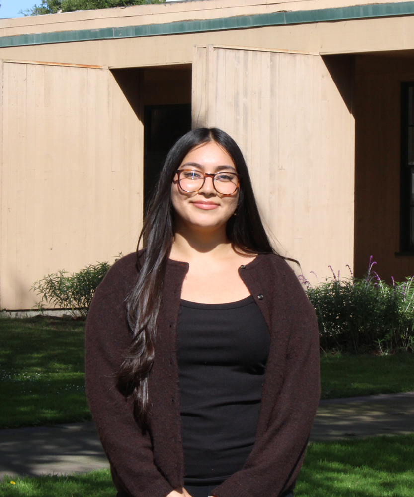 This is a headshot of Guardian Scholar Intern, Aileen. Aileen wears glasses and a brown cardigan.
