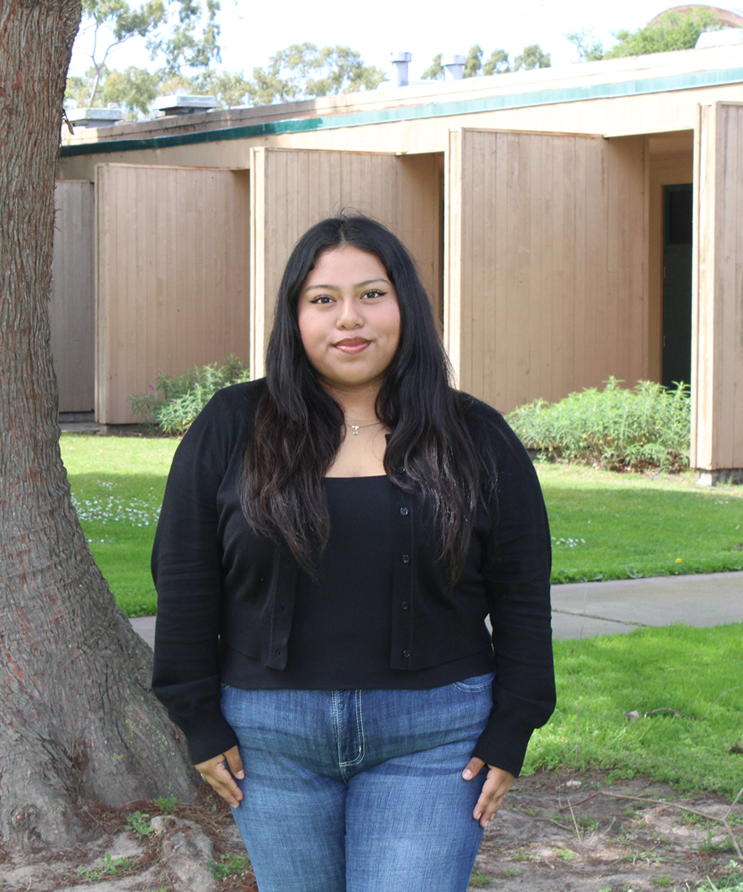 This is a headshot of Guardian Scholar Intern, Linsy. Lindsy wears a black cardigan with jeans.