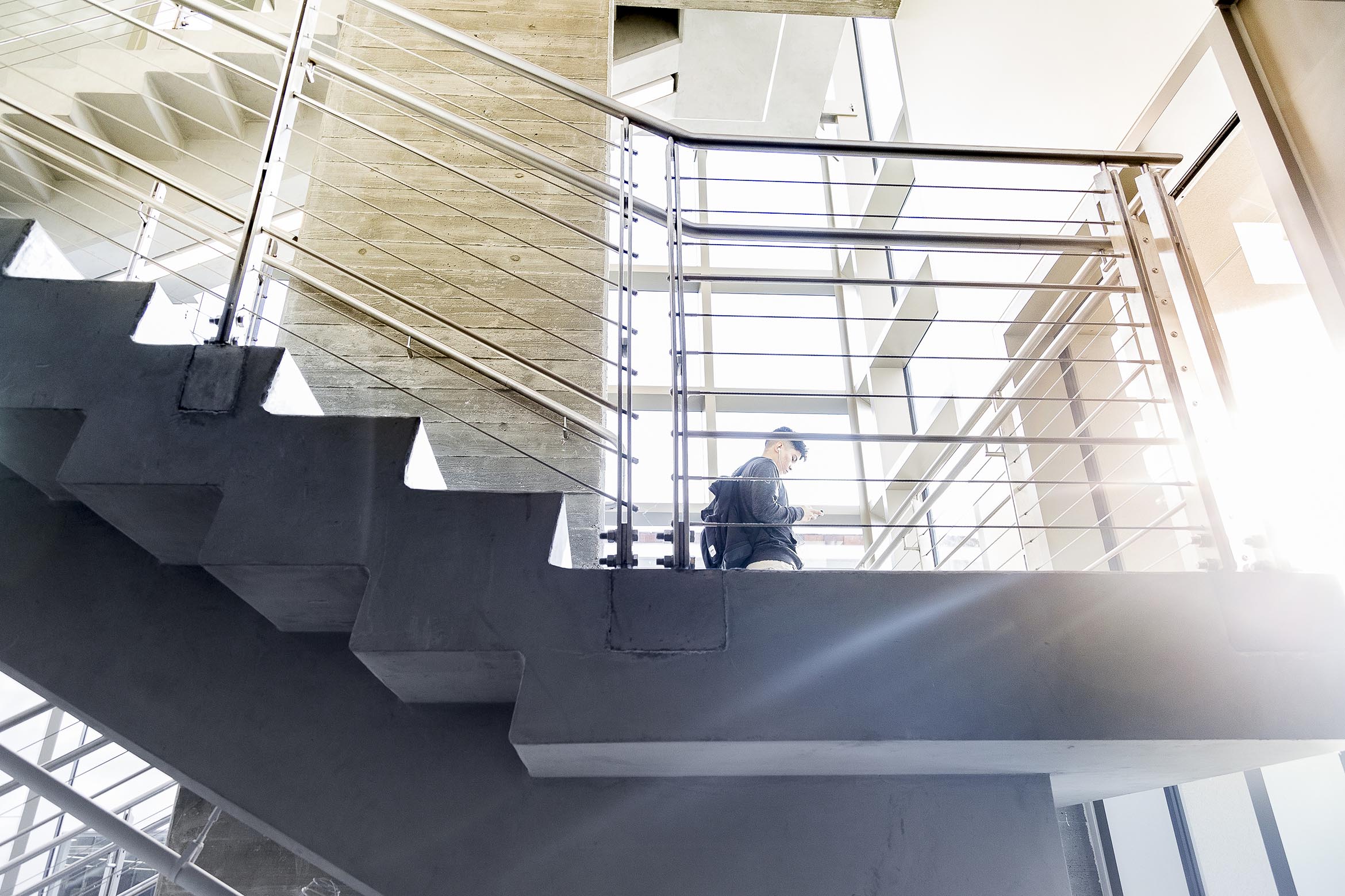 This is an image of a student walking down the library stairs.