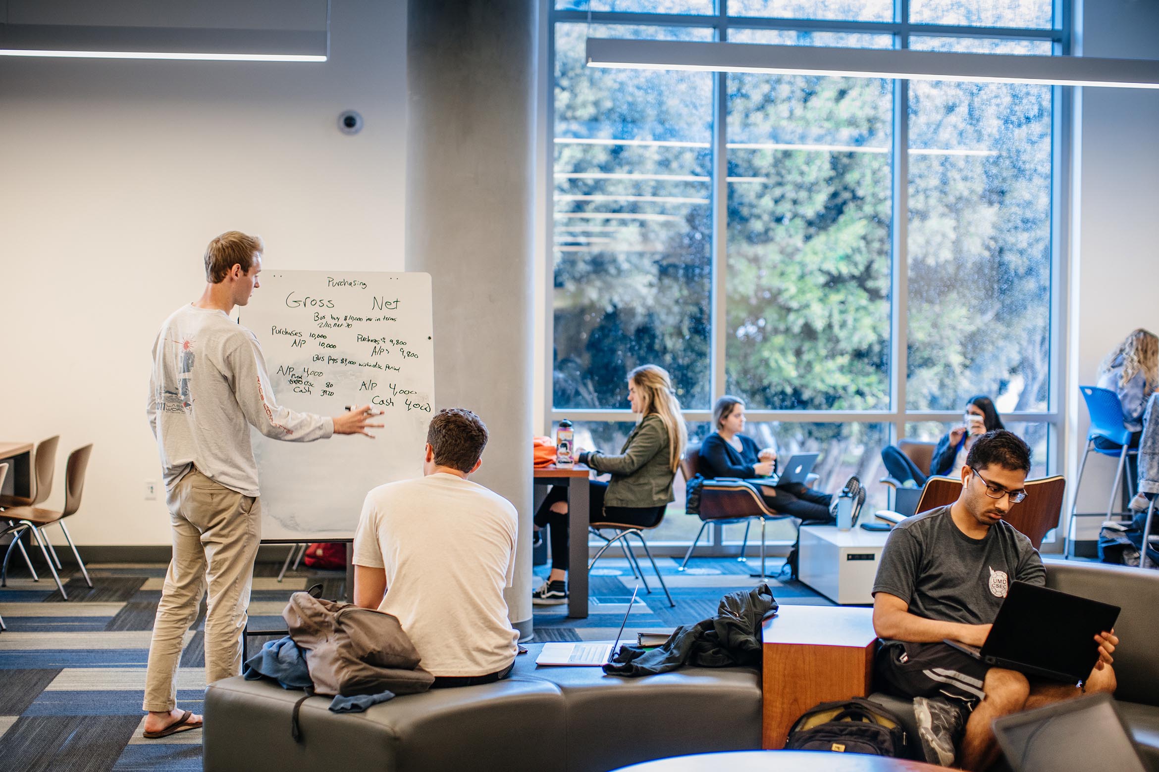 This is a student at a white board in the library.